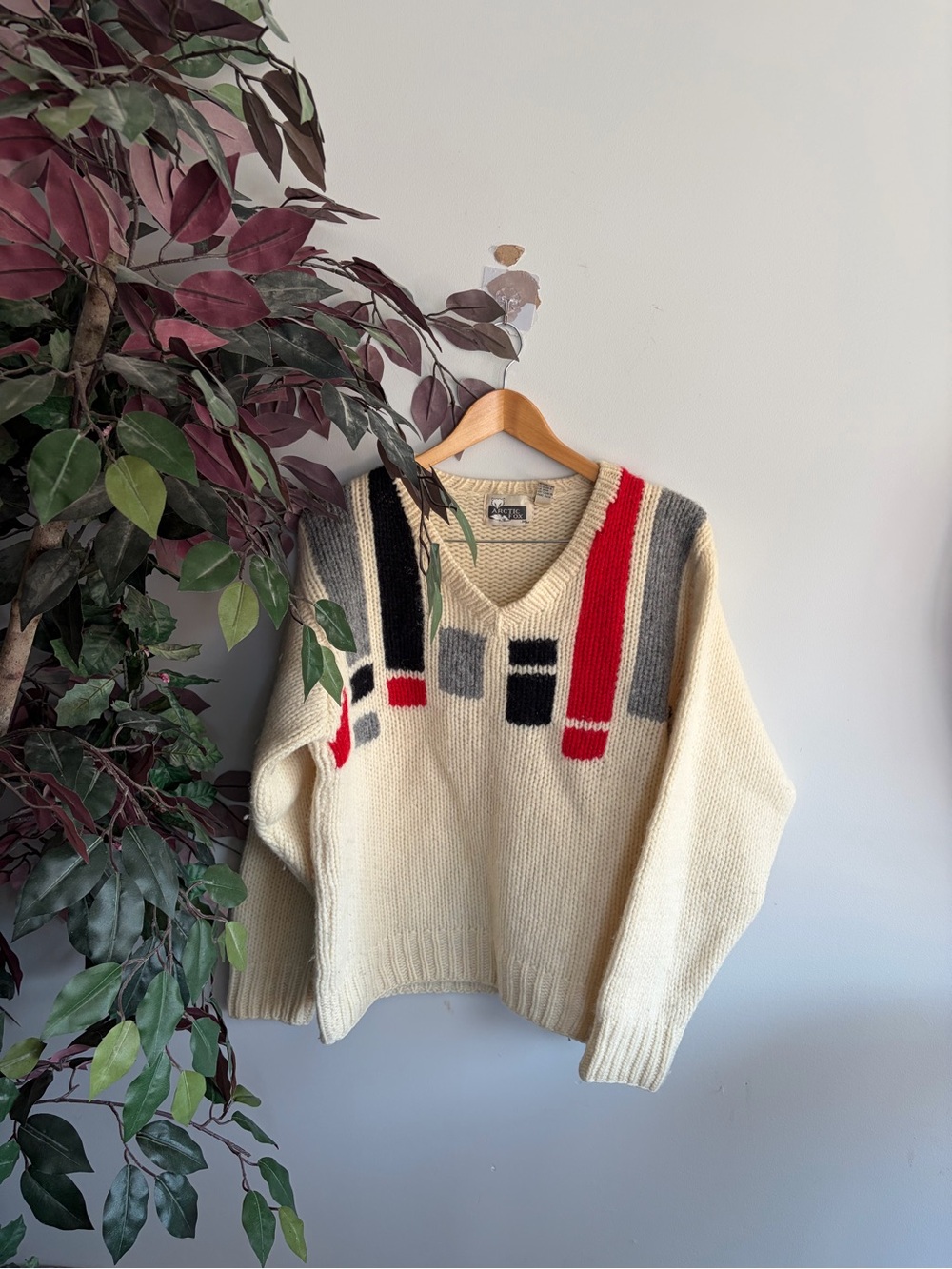 Cream V-Neck Sweater with Red, Black & Gray Stripe Detail